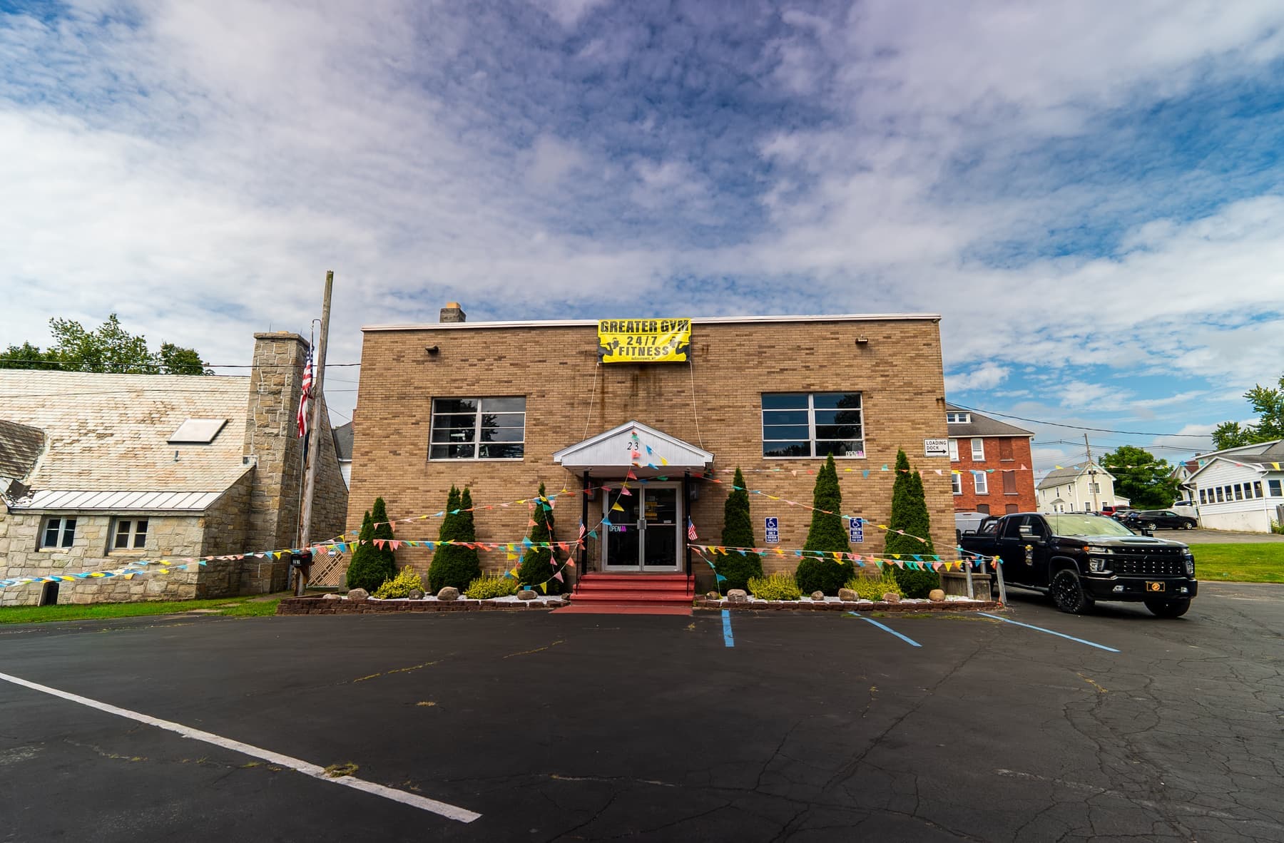 Greater Gym building at 23 Cayadutta St, Johnstown NY with the 24/7 Fitness banner